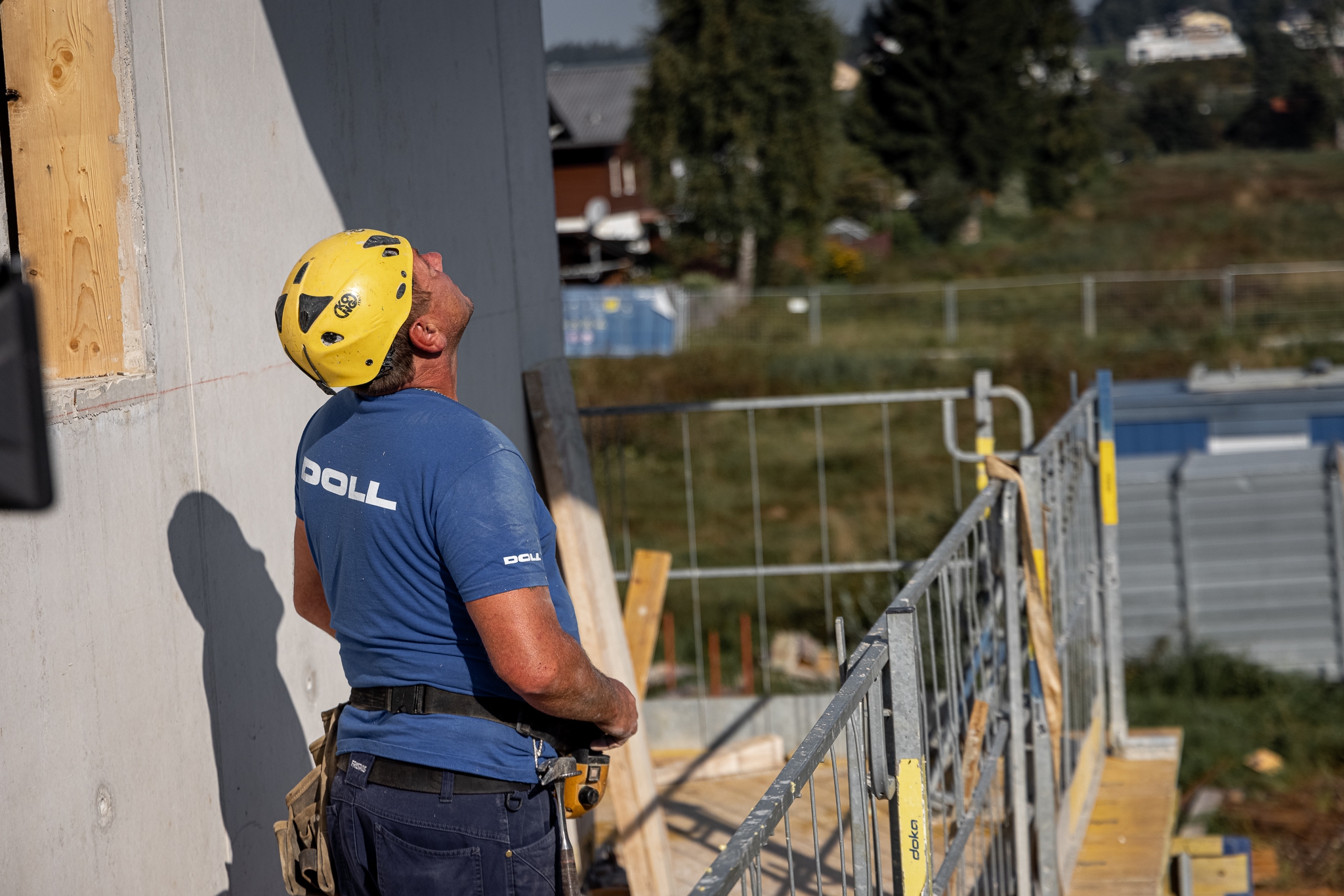 DOLL EFH Seekirchen Bauarbeiter schaut konzentriert auf Kran den er lenkt